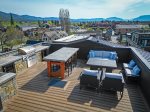 The shared rooftop patio offers guests access to an outdoor kitchen & grill, dining area & patio seating with gas fire pit.